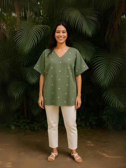 Oliva Kaftan Top- Handwoven Jamdani Cotton | Jhultaru. Fabric: 100% Handwoven Jamdani Cotton  Design: V-neck, kaftan cut, relaxed fit Woven motifs: Subtle white dots in geometric arrangement- Handwoven Jamdani Oliva Kaftan Top in soft sage green with woven motifs. A breathable, flowy silhouette in pure cotton for everyday ease.