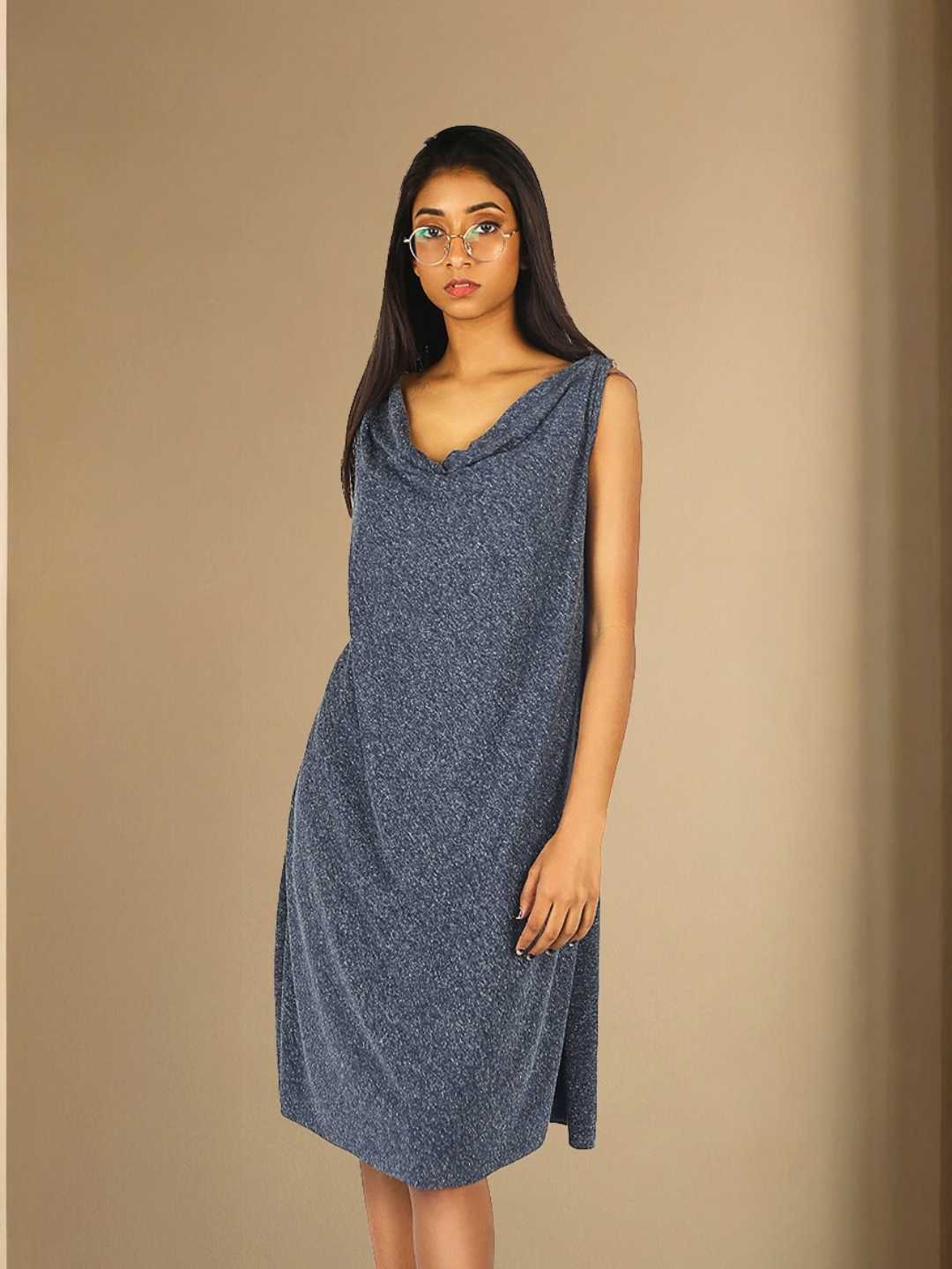 Nyra Dress – A cowl back-tie dress in grey hemp and recycled polyester, the Nyra Dress by Jhultaru balances bold drapes with a clean front. 85% recycled polyester + 15% hemp – eco-conscious, expressive, and effortlessly fluid.