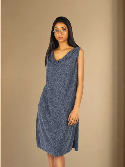 Nyra Dress – A cowl back-tie dress in grey hemp and recycled polyester, the Nyra Dress by Jhultaru balances bold drapes with a clean front. 85% recycled polyester + 15% hemp – eco-conscious, expressive, and effortlessly fluid.