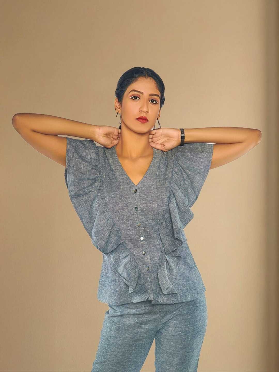 Kaia Top – A slate grey hemp top with front ruffle panels, the Kaia Top by Jhultaru reimagines workwear with fluid comfort and modern structure. Made from 100% hemp – breathable, biodegradable, and sustainably stylish.