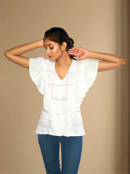 Iyla Top – A white hemp top with soft gathers and a ruffle detail, the Iyla Top by Jhultaru brings a delicate touch to everyday wear. Made from 100% hemp and Tencel – eco-friendly, sustainable, breathable, and timeless. Designed for effortless elegance with a conscious core.