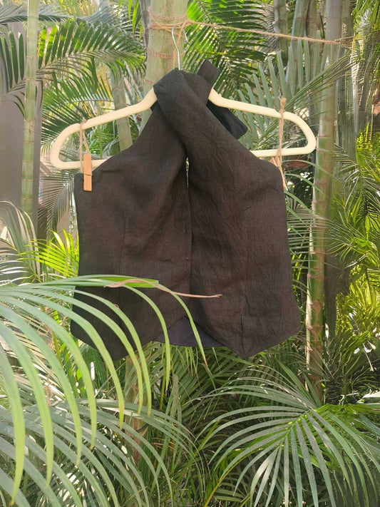 Noir Halter Vest-  Linen Vest in Deep Charcoal Black| Jhultaru. 100% Linen- lightweight, breathable, naturally textured, Sustainable and Eco-friendly.  Front closure: Hidden hook-eye- A sleeveless halter vest in charcoal black linen with a structured yet feminine fit. Noir is your versatile layer for the slow, bold days.