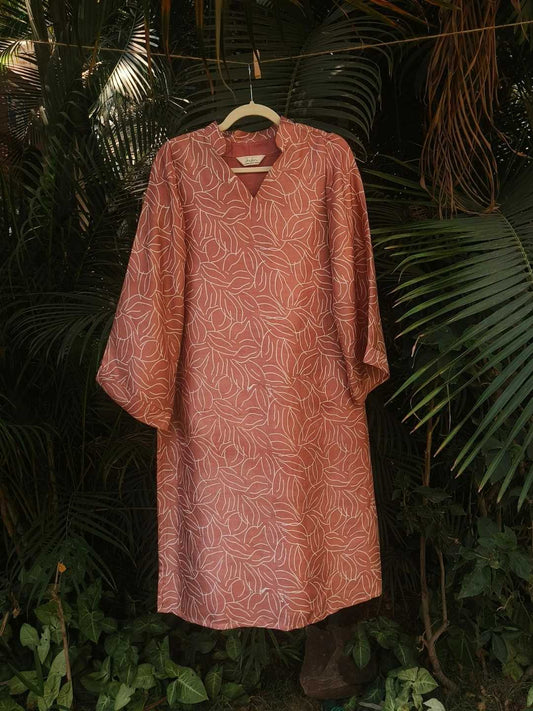 Sorbet Kurta- Kosa Silk | Jhultaru. Fabric: 100% Handwoven Kosa Silk  Color: Sorbet Pink with White Leaf Motif. Full sleeves with a soft flareV-neck with gathered detailing. A-line comfort fit. Naturally breathable and textural- Crafted in Kosa silk, the Sorbet Kurta is a soft pink silhouette with hand-printed leaf motifs. A wardorbe essential with mindful details.